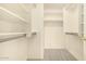 Walk-in closet featuring built-in shelving and rods for ample storage space at 9715 E Osage Ave, Mesa, AZ 85212
