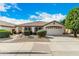 Charming single-story home with a well-manicured front yard, desert landscaping, and attached two-car garage at 9715 E Osage Ave, Mesa, AZ 85212