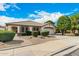 Inviting single-story home with a desert landscaped yard and brick pathway leading to the front entrance at 9715 E Osage Ave, Mesa, AZ 85212