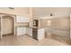 Modern kitchen with white cabinetry, stainless steel appliances, and granite countertops overlooking the living area at 9715 E Osage Ave, Mesa, AZ 85212