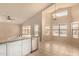 Bright kitchen featuring white cabinets, granite countertops, stainless steel appliances, and a breakfast bar at 9715 E Osage Ave, Mesa, AZ 85212