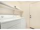 Convenient laundry room with washer, dryer, shelving, and easy access to the backyard at 9715 E Osage Ave, Mesa, AZ 85212