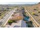An aerial view of homes in a desert community featuring mountain views and easy access to paved roads at 10038 W Redbird Rd, Peoria, AZ 85383