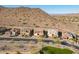 A high angle view of homes with tile roofs surrounded by desert landscaping in a planned community at 10038 W Redbird Rd, Peoria, AZ 85383