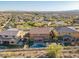 A high angle view of homes with backyard pools in a planned desert community at 10038 W Redbird Rd, Peoria, AZ 85383