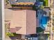 An aerial view of a home with a red tile roof and a beautiful backyard pool and patio area at 10038 W Redbird Rd, Peoria, AZ 85383