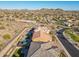 A view of homes in a planned desert community nestled amongst desert landscaping and distant mountain views at 10038 W Redbird Rd, Peoria, AZ 85383