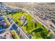 Aerial view of a neighborhood park with a playground, desert landscaping, and walking paths at 10038 W Redbird Rd, Peoria, AZ 85383