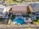 A high angle view of a home featuring a backyard pool, patio, and well maintained landscaping at 10038 W Redbird Rd, Peoria, AZ 85383