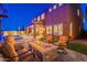Gorgeous backyard featuring a fire pit, a swimming pool, lush artificial turf, and the home's exterior at 10038 W Redbird Rd, Peoria, AZ 85383