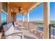 Inviting balcony featuring comfortable seating, decorative iron railings, and scenic neighborhood views with clear blue skies at 10038 W Redbird Rd, Peoria, AZ 85383