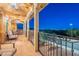 Covered balcony with wrought iron railing and extensive city views at twilight at 10038 W Redbird Rd, Peoria, AZ 85383