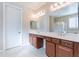 Well-lit bathroom with dual sinks, a vanity, and tiled flooring, showcasing a serene atmosphere at 10038 W Redbird Rd, Peoria, AZ 85383