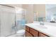 Bathroom featuring a walk-in shower with glass enclosure, wood vanity, and mirrored medicine cabinet at 10038 W Redbird Rd, Peoria, AZ 85383