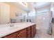 Bathroom showcasing a spacious vanity, neutral wall paint, decorative mirror, with tub and shower combo at 10038 W Redbird Rd, Peoria, AZ 85383