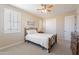 This bedroom features neutral walls, carpet, a ceiling fan, and a wardrobe at 10038 W Redbird Rd, Peoria, AZ 85383