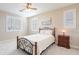 This bedroom features neutral walls, a ceiling fan, carpet, and shutters on the windows at 10038 W Redbird Rd, Peoria, AZ 85383