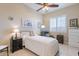 Cozy bedroom with tile floors, plantation shutters, and comfortable furnishings at 10038 W Redbird Rd, Peoria, AZ 85383