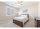 This bedroom features neutral walls, carpet, a ceiling fan, and shutters on the windows at 10038 W Redbird Rd, Peoria, AZ 85383