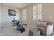 Bright bedroom with gym equipment, chair, and plantation shutters at 10038 W Redbird Rd, Peoria, AZ 85383