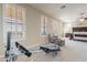 Bedroom area featuring home gym equipment, seating and plantation shutters at 10038 W Redbird Rd, Peoria, AZ 85383