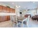 Open dining area with wood cabinets, eat-in dining, and access to the living room at 10038 W Redbird Rd, Peoria, AZ 85383