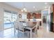 Cozy dining area near a kitchen, offering a sliding door access to outside entertainment at 10038 W Redbird Rd, Peoria, AZ 85383