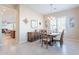 Dining area boasts wood table, complementary chairs, lovely decor, and abundant natural light at 10038 W Redbird Rd, Peoria, AZ 85383