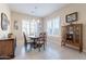Inviting dining room showcasing a classic table set, a charming hutch, and plantation shutters at 10038 W Redbird Rd, Peoria, AZ 85383