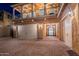 Two-story home with large garage doors, decorative front door and lighting at 10038 W Redbird Rd, Peoria, AZ 85383