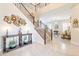 Spacious foyer with staircase, console table, and a view into the living area at 10038 W Redbird Rd, Peoria, AZ 85383