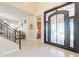 Grand foyer showcasing a decorative front door, soaring ceilings, and an elegant staircase at 10038 W Redbird Rd, Peoria, AZ 85383