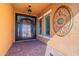 Close-up of the front entrance with decorative door, sidelight windows, and porch decor at 10038 W Redbird Rd, Peoria, AZ 85383
