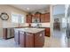 Kitchen offers granite countertops, stainless appliances, central island, and wood cabinets at 10038 W Redbird Rd, Peoria, AZ 85383