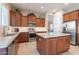 Well-equipped kitchen features granite countertops, stainless steel appliances, and custom wood cabinetry at 10038 W Redbird Rd, Peoria, AZ 85383