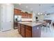 Spacious kitchen featuring a central island, stainless steel refrigerator, and wood cabinets at 10038 W Redbird Rd, Peoria, AZ 85383