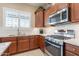 Gourmet kitchen features stainless steel appliances, granite countertops, and custom cabinetry at 10038 W Redbird Rd, Peoria, AZ 85383