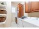 Functional laundry room with shelving, washer, dryer, and storage cabinets at 10038 W Redbird Rd, Peoria, AZ 85383