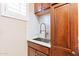 Laundry sink with modern faucet and cabinets at 10038 W Redbird Rd, Peoria, AZ 85383