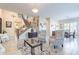 Bright and spacious living room with tile floors, elegant furnishings, and a view of the staircase at 10038 W Redbird Rd, Peoria, AZ 85383