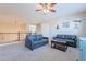 Open living space with comfortable sofas, a ceiling fan, and scenic wall decorations at 10038 W Redbird Rd, Peoria, AZ 85383