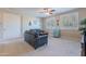 Cozy living room featuring seating, neutral colors, plantation shutters, and a small refrigerator at 10038 W Redbird Rd, Peoria, AZ 85383