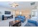 Spacious living area showcasing modern furniture, a ceiling fan, and an open floor plan at 10038 W Redbird Rd, Peoria, AZ 85383