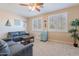 Comfortable living room featuring seating, neutral colors, plantation shutters, and a small refrigerator at 10038 W Redbird Rd, Peoria, AZ 85383