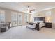 Spacious primary bedroom featuring a ceiling fan, neutral colors, French doors, and plantation shutters at 10038 W Redbird Rd, Peoria, AZ 85383