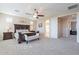 Inviting main bedroom with a ceiling fan, a decorative headboard, and neutral-toned walls at 10038 W Redbird Rd, Peoria, AZ 85383