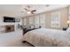 Bright primary bedroom with sitting area, home gym equipment, and balcony access at 10038 W Redbird Rd, Peoria, AZ 85383