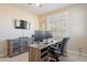 This office features neutral walls, carpet, a ceiling fan, and shutters on the windows at 10038 W Redbird Rd, Peoria, AZ 85383