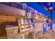 Outdoor kitchen features a built-in natural gas grill, stone countertops, and a refrigerator at 10038 W Redbird Rd, Peoria, AZ 85383