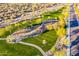 Aerial view of a neighborhood playground with green grass, walkways, and desert landscaping at 10038 W Redbird Rd, Peoria, AZ 85383